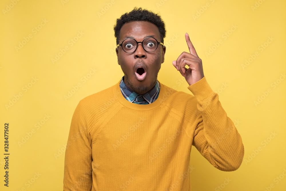 Canvas Prints african man pointing upwards showing idea or eureka gesture.