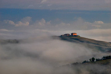 Fototapeta premium Beautiful view of the Tuscan fields in the morning mists, Pievina, Siena Province, Tuscany, Italy, Europe