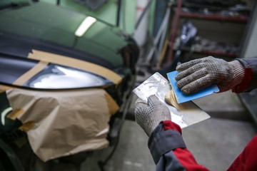 preparation of a car part for painting in a car painting shop
