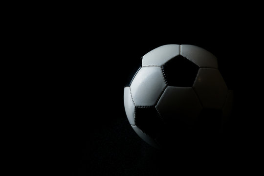 ball with shadow on black background with copy space