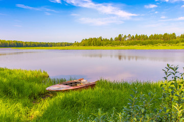 Iron boat and calm river horizontal view. Summer landscape