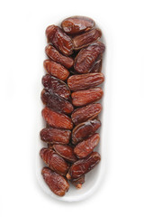 Dried dates ina plastic bowl isolated on white background. Date fruits on white