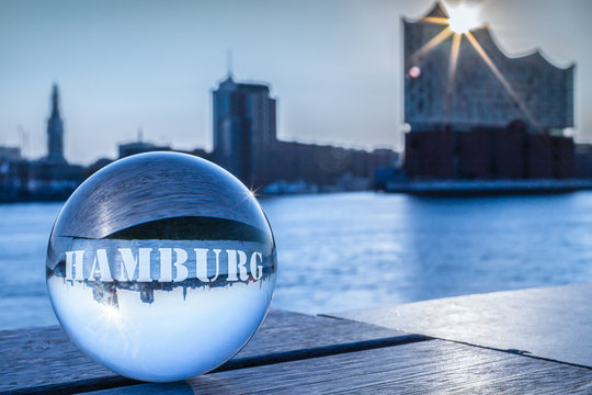 Elbphilharmonie Hamburg reflects in a glass globe with text Hamburg