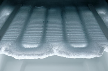Time to defrost : View into the freezer on cooling coils completely covered with ice.
