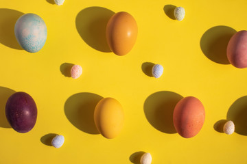 Colorful Easter eggs patterns on yellow background