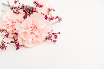 bouquet of flowers on the white background, symbol of love, pink or beije carnations and small decoration branch
