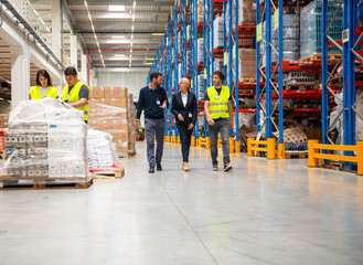 Managers and workers in warehouse