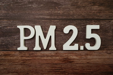 PM 2.5 alphabet letter on wooden background