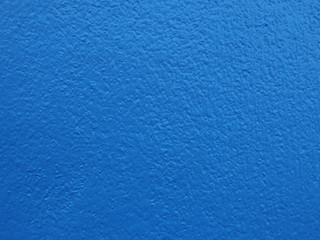 Fototapeta na wymiar A clean blue wall with textures on surface. Color, building and construction ideas. 