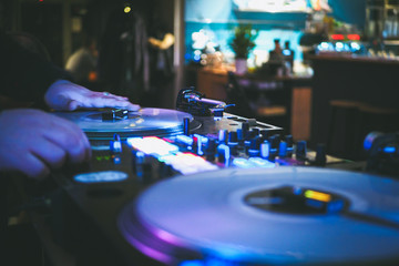 DJ vinyl players in dark nightclub, party in the dance club, DJ equipment, defocused	