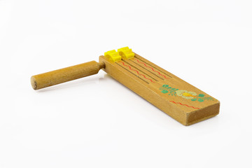 Traditional Slovak folk wooden product with floral motif, symbol of Easter. Ratchet separated on white background.