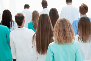 Fototapeta premium top view. a group of smiling doctors pointing at you.