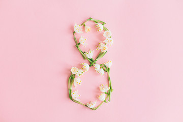 8 march. Floral number 8 made of spring flowers on pink background, stylish spring greeting card. Happy womens day concept. International women's day. Flat lay