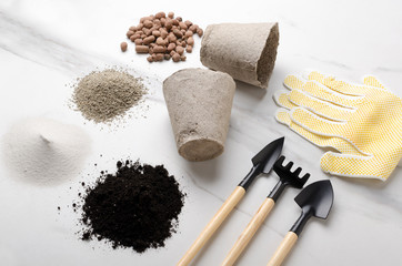 Kit of gardening tools, sand, solid, expanded clay, pots on the white surface