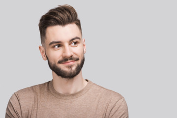 Closeup portrait of handsome smiling young man. Laughing joyful cheerful men studio shot. Isolated on gray background	