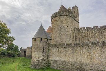 Fototapeta premium Medieval citadel at Carcassonne - huge and completely over-the-top, encompassing no less than 53 towers, enormous concentric walls, surrounded by a moat. Aude department, region of Occitanie, France.