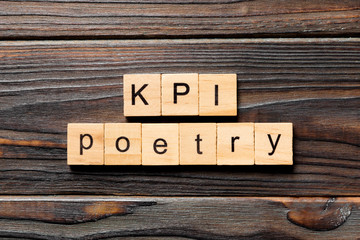 KPI poetry word written on wood block. KPI poetry text on table, concept