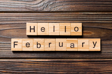 Hello February word written on wood block. Hello February text on table, concept