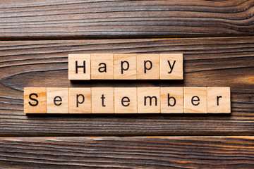 Happy september word written on wood block. Happy september text on table, concept