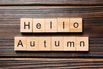 Hello autumn word written on wood block. autumn text on wooden table for your desing, concept