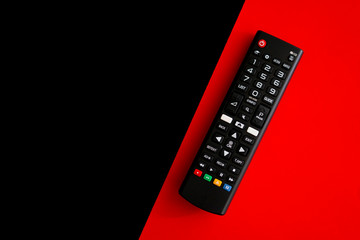 Black TV control on a black and red background.