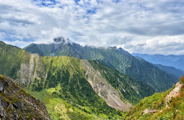 Overcast clouds over mountain ranges. The state of nature before rain. Eastern Sayan. Russia