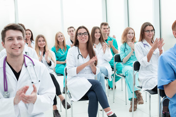 Obraz premium top view. a group of smiling doctors pointing at you.