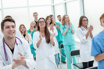 top view. a group of smiling doctors pointing at you.