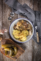Fried liver with onion and apple, served with boiled potatoes and pickled cucumber.