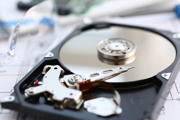 Hard drive from computer or laptop lies on the table in the repair shop. Performs fault diagnostics and performs urgent repairs recovery of lost data during deletion HDD closeup