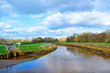 Fototapeta premium Beautiful landscape of the tree and canal with blue and grey sky nature background in sunshine day and good weather at spring or summer season at Lier, Antwerp, Belgium. Travel and holiday concept.