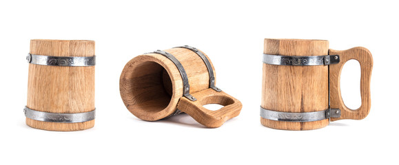 Old vintage wooden beer mugs from different angles on a light isolated background with metal mounts.