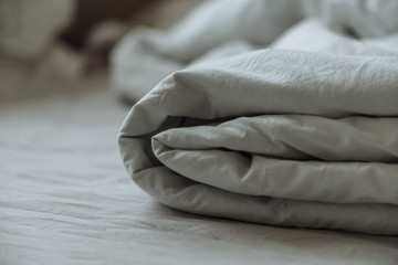 Fototapeta na wymiar folded gray bedding fabrik cotton