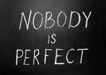Nobody is perfect written in white chalk on a black chalkboard