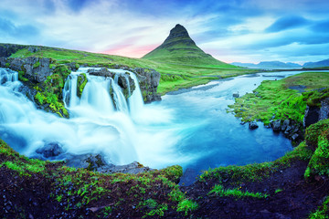 Unique landscape with Kirkjufellsfoss waterfall and Kirkjufell mountain, Iceland, Europe.