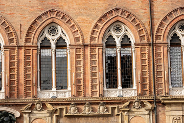 Closeup of ancient mullioned windows (bifore) of the Palazzo d'Accursio, Town hall in downtown of Bologna (XIII century), Piazza Maggiore, Emilia-Romagna, Italy, Europe
