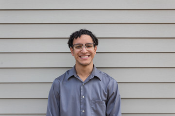 Young mixed race millennial male, big happy smile, facing camera, young professional, horizontal aspect