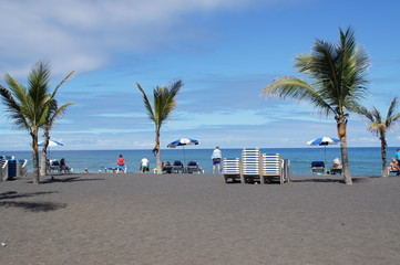 picturesque Playa Jardín beach on the Spanish Canary Island Tenerife with black volcanic sand blue...