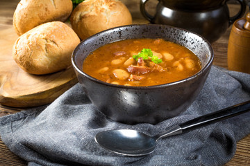 Beans with tomato sauce, bacon and sausage.