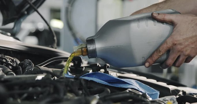 Car Service Worker Changes Oil In The Car