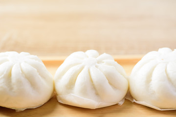 Fototapeta na wymiar Steamed buns on wooden plate ready to eating, Asian food