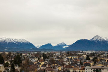 central European city top view moody colors and cloudy weather time Alps mountains scenic background view
