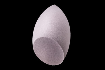 Makeup tool sponge or beauty blender isolated on black background