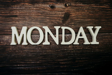 Monday alphabet letter on wooden background