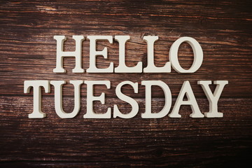 Hello Tuesday alphabet letter with space copy on wooden background