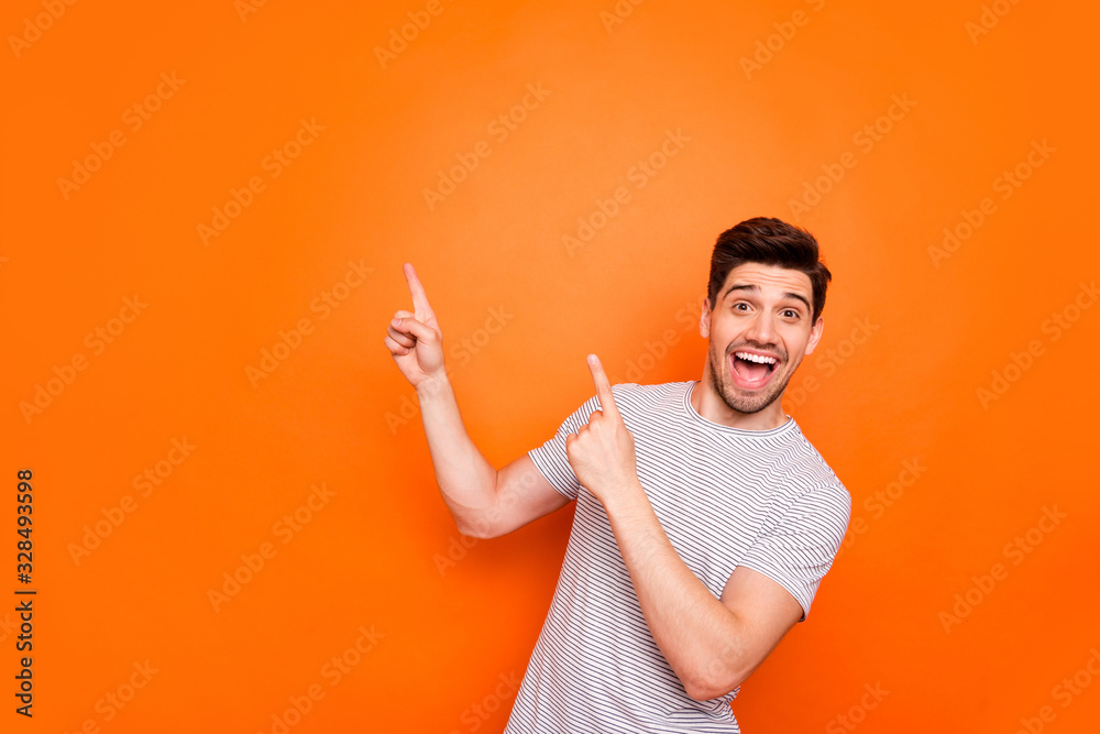 Wall mural photo of attractive guy hold hands fingers direct up empty space excited good mood sales person wear - Wall murals