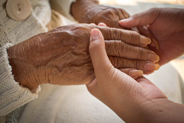  Hand of a woman looking after the elderly