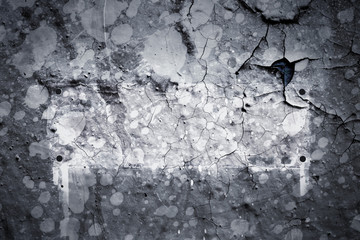 Surface texture with gray splashes of paint on a cracked surface structure of a concrete wall with a shield or frame. For abstract backgrounds.