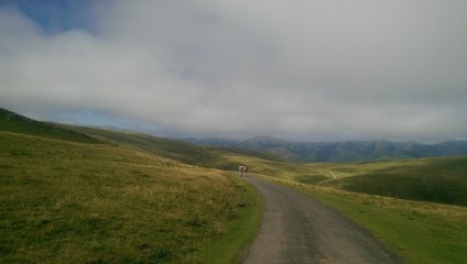 Pilgrims walking in the Pyrenees mountains, on the border between France and Spain. Roncesvalles. Pilgrimage of Compostela, Camino de santiago.