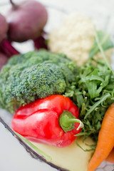 Fresh raw vegetables in the metal basket.